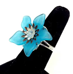 Blue resin flower ring on display
